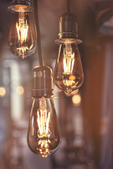 Fototapeta na wymiar Old Style Glowing Light Bulbs Hanging in Bar