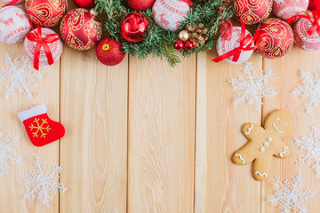 Christmas background with decorations, gingerbread and balls on wooden board