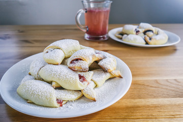 Freshly baked croissants with rose jam
