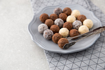Assorted chocolate truffles with cocoa powder, coconut and chopp
