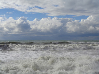 Storm waves and clouds over the sea