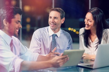 Smiling businessman discussing with colleagues