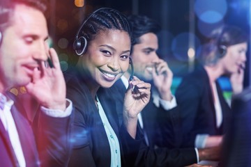 Happy colleagues with headsets at office