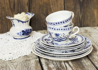 Clean dishes - cups and plates - on a wooden table