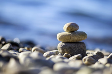 Zen balancing pebbles on the beach