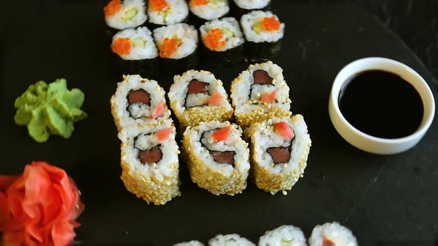  motion of sushi food served on black stone wasabi ginger