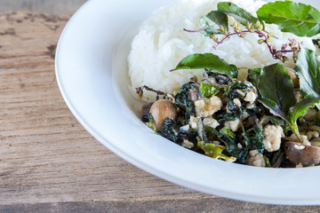 Thai food, rice topped with stir-fried minced pork and basil and barometer earthstar
