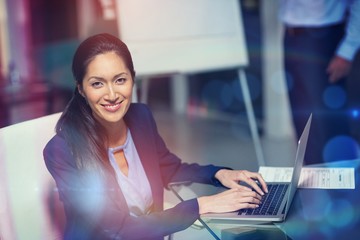 Portrait of businesswoman working on laptop