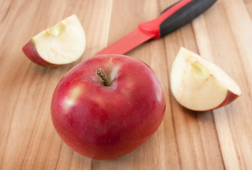 Naklejka na ściany i meble Apples and kitchen knife on wooden surface.