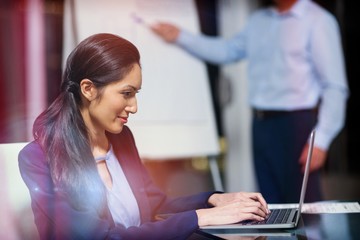 Portrait of businesswoman working on laptop