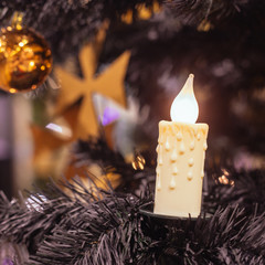 Christmas tree with a candle, a ball and a Maltese cross - 129586978