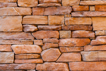 Stone brick wall background in orange color.