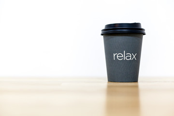 Coffee cup on wood table and white background.