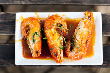 Thai Food shrimps in spicy curry sauce with herb.