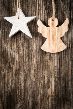 Christmas angel and star over wooden background