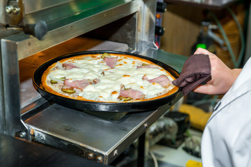delicious italia pizza in a restaurant, on the wooden desk