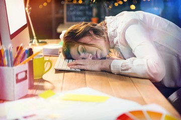 Tired businesswoman sleeping on desk