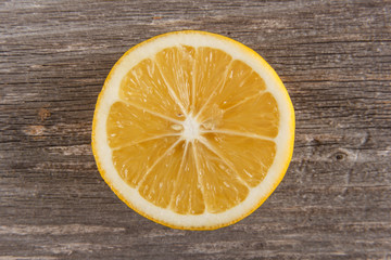 Half of lemon on gray board/Close up of lemon