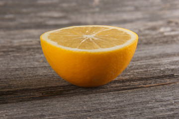 Half of lemon on gray board/Close up of lemon