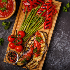 Grilled vegetables with tomato sauce and fresh herbs.