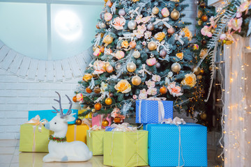 Christmas living room with Christmas tree and gifts under it.