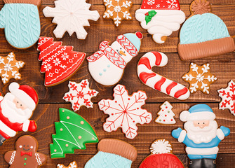 Homemade delicious Christmas gingerbread cookies on the wooden background