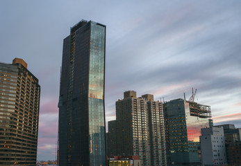 Colorful clouds reflecting in glass facades of Manhattan buildin - 129594739