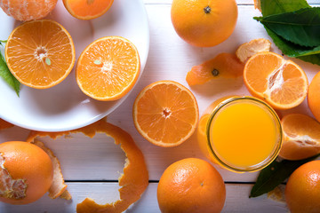 Orange juice on white wooden table. Top view