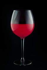 Glass of pink wine on black