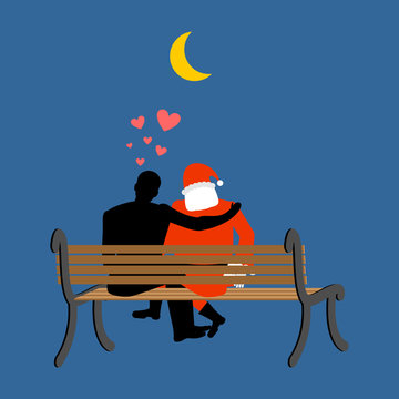Christmas Lover. Santa Claus and man looking at moon. Date night