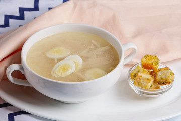 Chicken clear broth with quail eggs and crackers