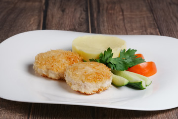 salmon cutlet with mashed potato and vegetables