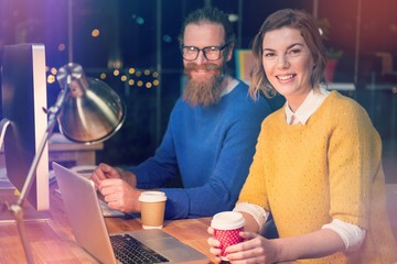 Businesswoman and colleague at desk