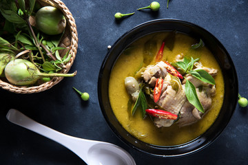 Thai food chicken green curry on dark wooden background. top view