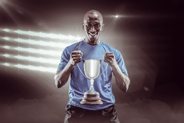 Fototapeta na wymiar Composite image 3D of portrait of happy sportsman holding trophy