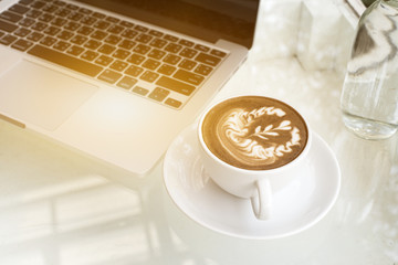 Coffee and cover up laptop on table,business concept