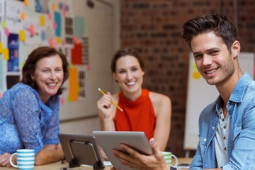 Business people discussing over digital tablet