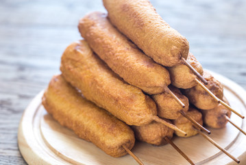 Stack of corn dogs on the wooden board