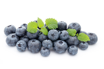 Close up of a blueberry branch isolated over white.