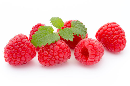 Ripe red raspberries isolated on white background.