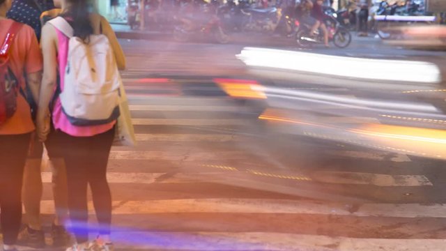 Blurred motion of cars and people on the pedestrian pedestrian passage. Vietnam.
