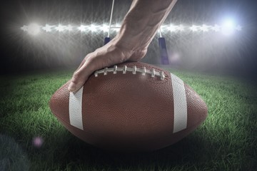 Composite image of american football player holding ball 3D