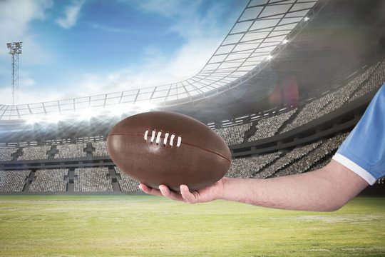 Composite image of rugby player handing a rugby ball 3D