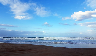 Deserted beach near the blue sea