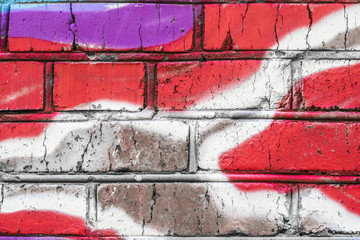 Brick wall with grafitti. Colorful painted close up