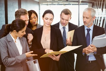 Lawyer looking at documents and interacting with business people