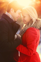 Winter portrait beautiful happy young couple in love, sunny warm
