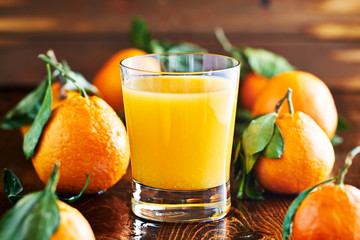 fresh glass of orange juice on rustic table top