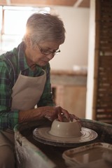 Female potter making a pot