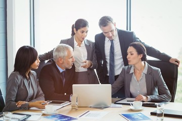 Businesspeople interacting in conference room